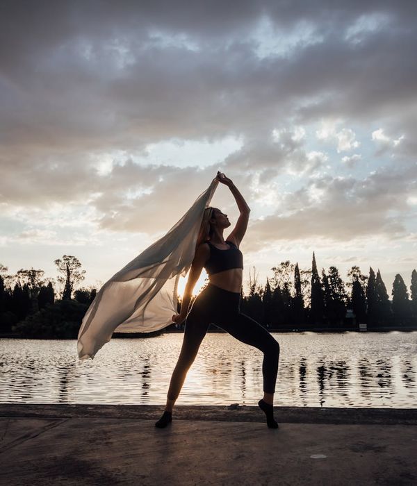 Woman in a graceful yoga pose, illustrating fluidity and movement.